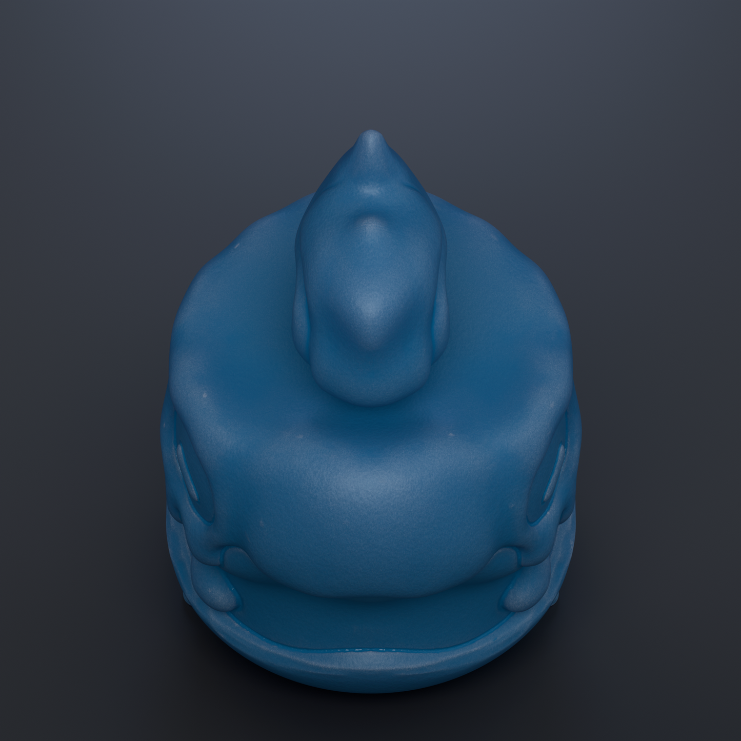 A blue, round object resembling a toy or figurine is shown against a dark background.