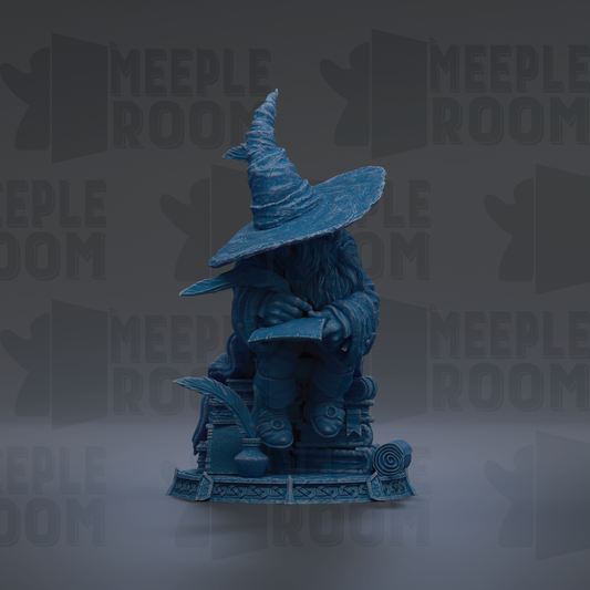 A blue statue of a wizard sitting on a pedestal, wearing a pointed hat and holding a book.
