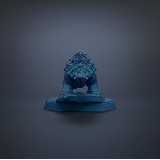 A blue figurine of a creature with a textured, armored appearance is displayed against a dark background.