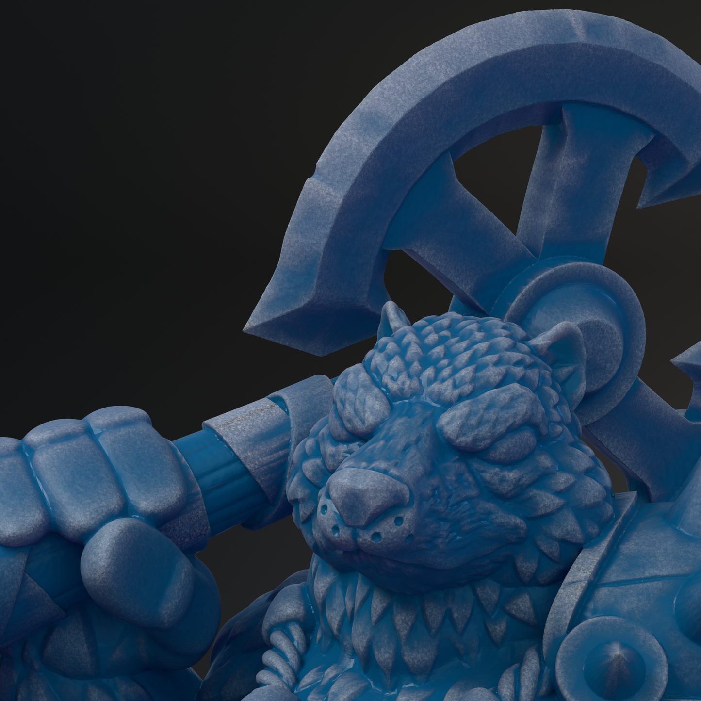 A close-up view of a blue, sculpted statue depicting a fierce-looking creature with sharp teeth and claws.