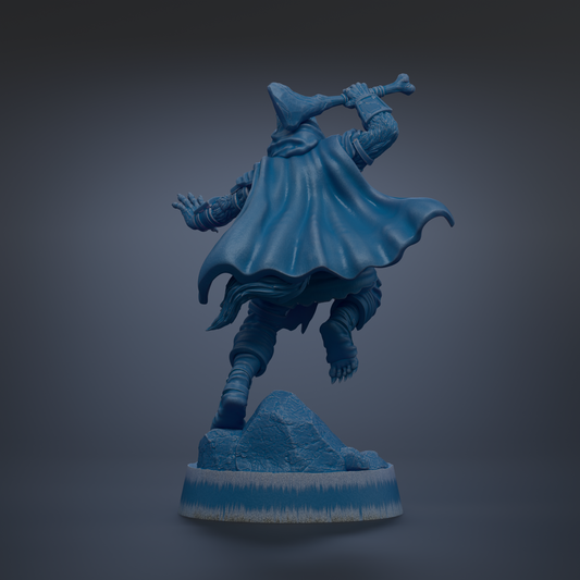 A blue statue of a figure in a cape, holding a weapon, standing on a rock formation.