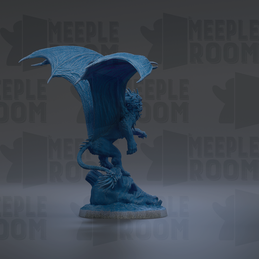 A blue dragon statue with wings spread, standing on a rock.
