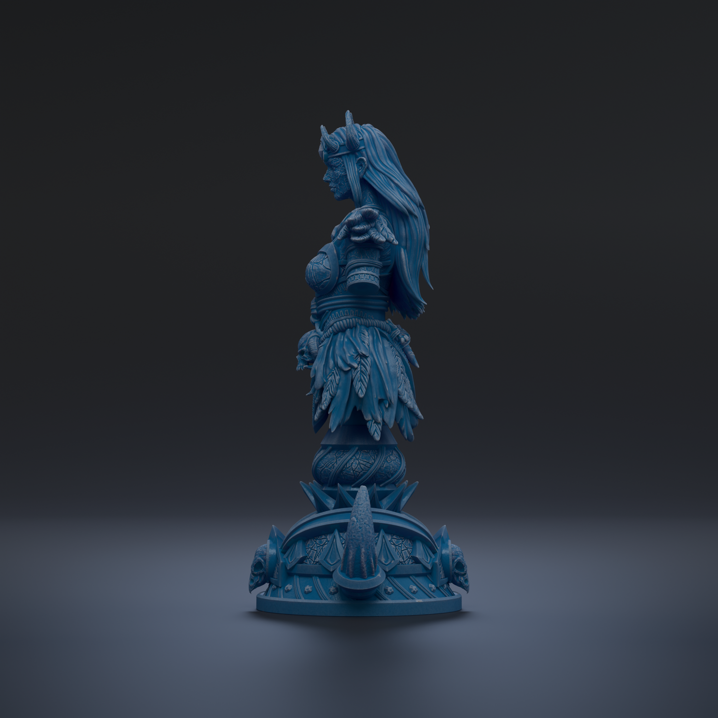 A blue statue of a woman with long hair and a crown, standing on a pedestal with intricate designs.