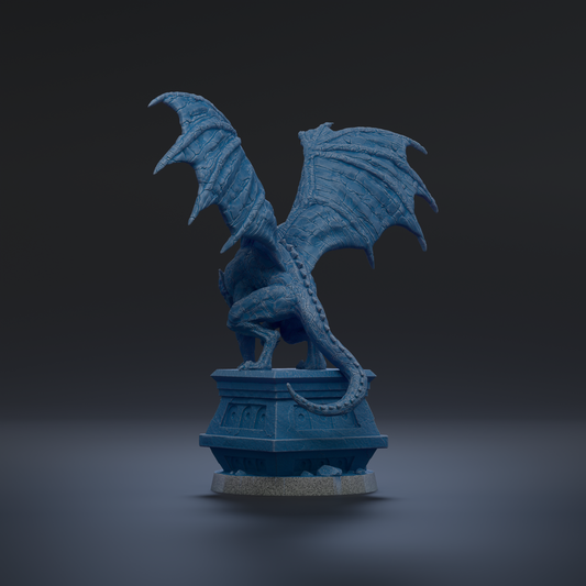 A blue dragon statue with wings spread, standing on a pedestal against a dark background.