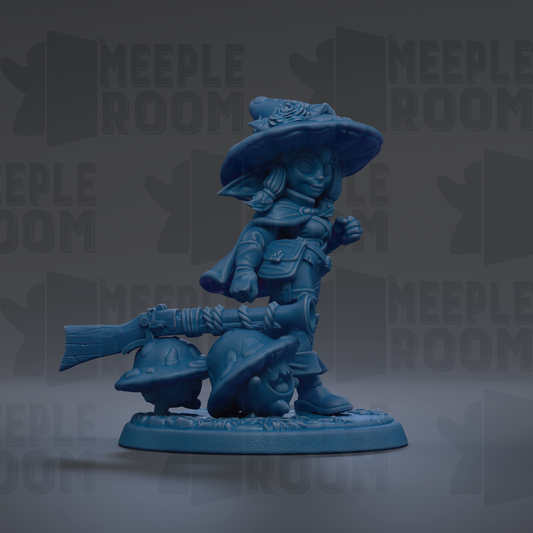 A blue figurine of a character with a pointed hat and a bow, standing on a base with a smaller character on it.