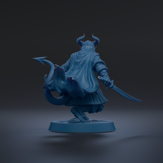 A blue figurine of a character with horns and a flowing cape, holding a sword and standing on a base.