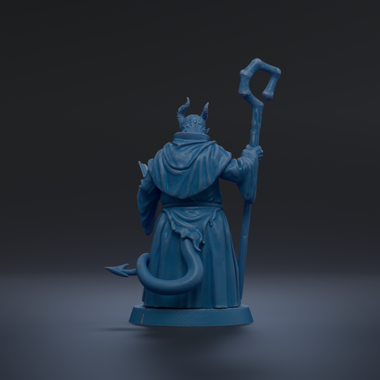 A blue figurine of a figure holding a staff and a tail, standing against a dark background.