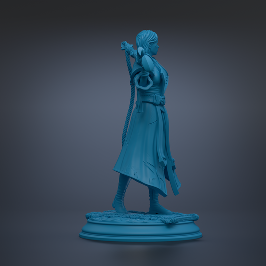 A blue statue of a person standing on a pedestal, holding a sword in their right hand.