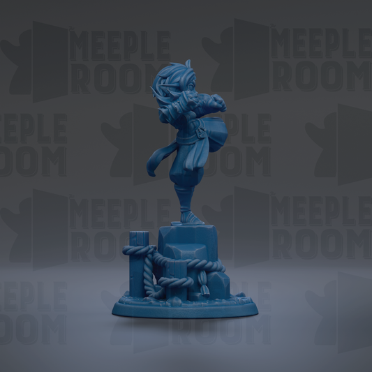 A blue figurine of a person standing on a pedestal, with a rope and other objects around it.