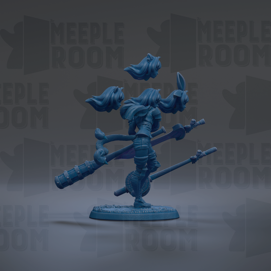 A blue figurine of a female character with flowing hair and a sword, standing on a base and holding a staff.
