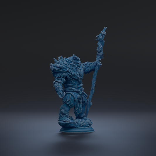 A blue figurine of a fantastical creature, possibly a dragon or serpent, standing on a pedestal and holding a staff or staff-like object.