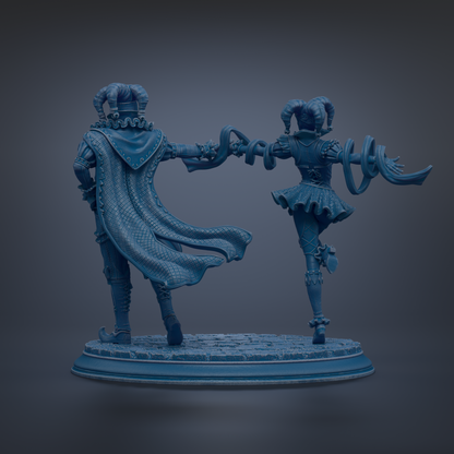 A statue of a man and a woman standing together, with the man wearing a cape and the woman wearing a dress.