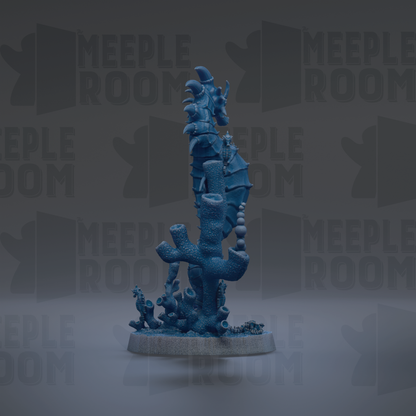 a blue, abstract sculpture resembling a sea creature or marine life, placed on a base and surrounded by other similar sculptures.