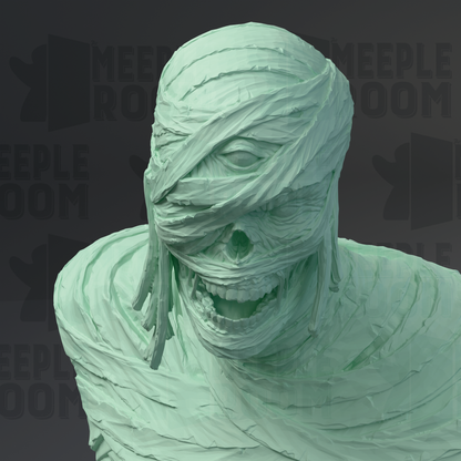 A green, sculpted statue of a person with a wrapped cloth covering their face, resembling a mummy or mummy-like figure.