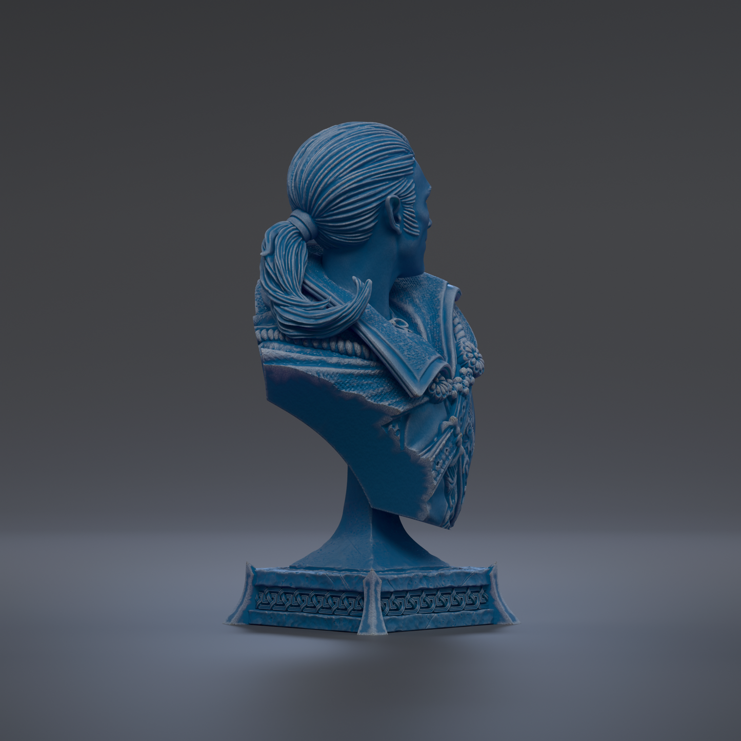 A blue bust sculpture of a person with long hair and a decorative design on the chest.