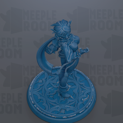 A blue figurine of a female character with a large head and flowing hair, standing on a decorative base with a floral pattern.