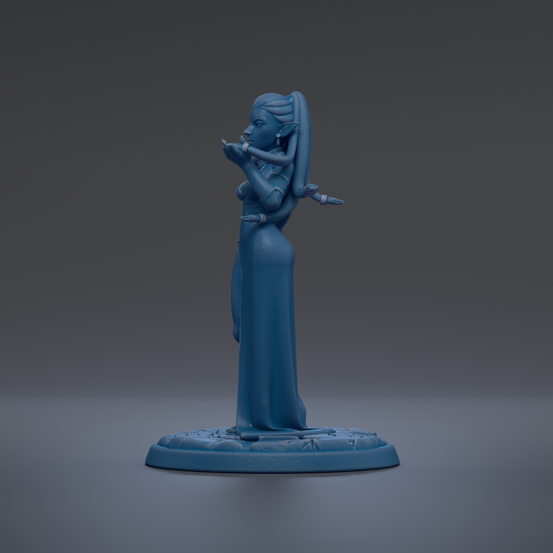 A blue figurine of a woman with a long dress and a long hairpiece stands on a blue base against a dark background.