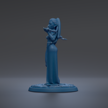 A blue figurine of a woman with a long dress and a long hairpiece stands on a blue base against a dark background.