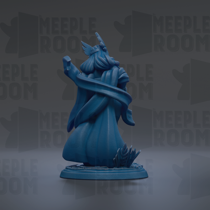 A blue figurine of a winged figure with a flowing robe, standing on a base and holding a staff.