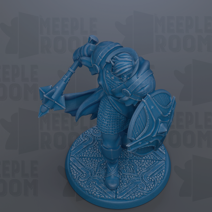 A blue figurine of a warrior figure holding a shield and sword, standing on a decorative base.