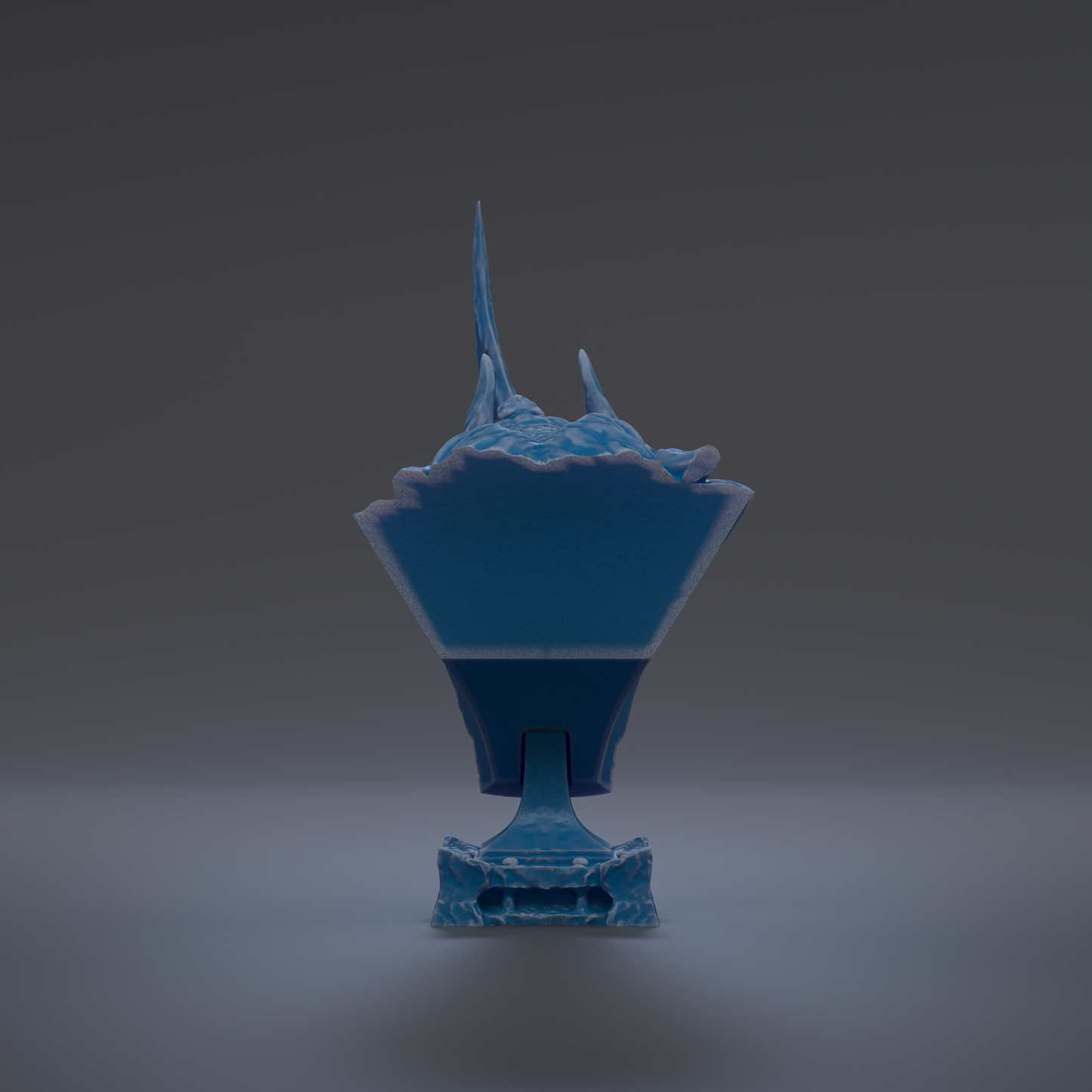A blue, three-dimensional object with a pointed top and a flat bottom, standing alone against a dark background.