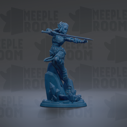 A blue figurine of a female warrior standing on a rock, holding a sword in her right hand.