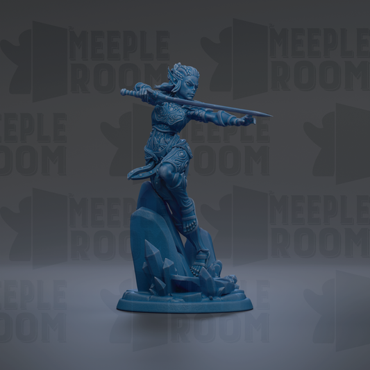 A blue figurine of a female warrior standing on a rock, holding a sword in her right hand.