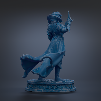 A statue of a person in a flowing robe and hat, holding a sword and standing on a pedestal.