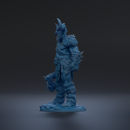 A blue, 3D-rendered statue of a warrior figure with a fierce expression and ornate armor, standing on a rock formation against a dark background.
