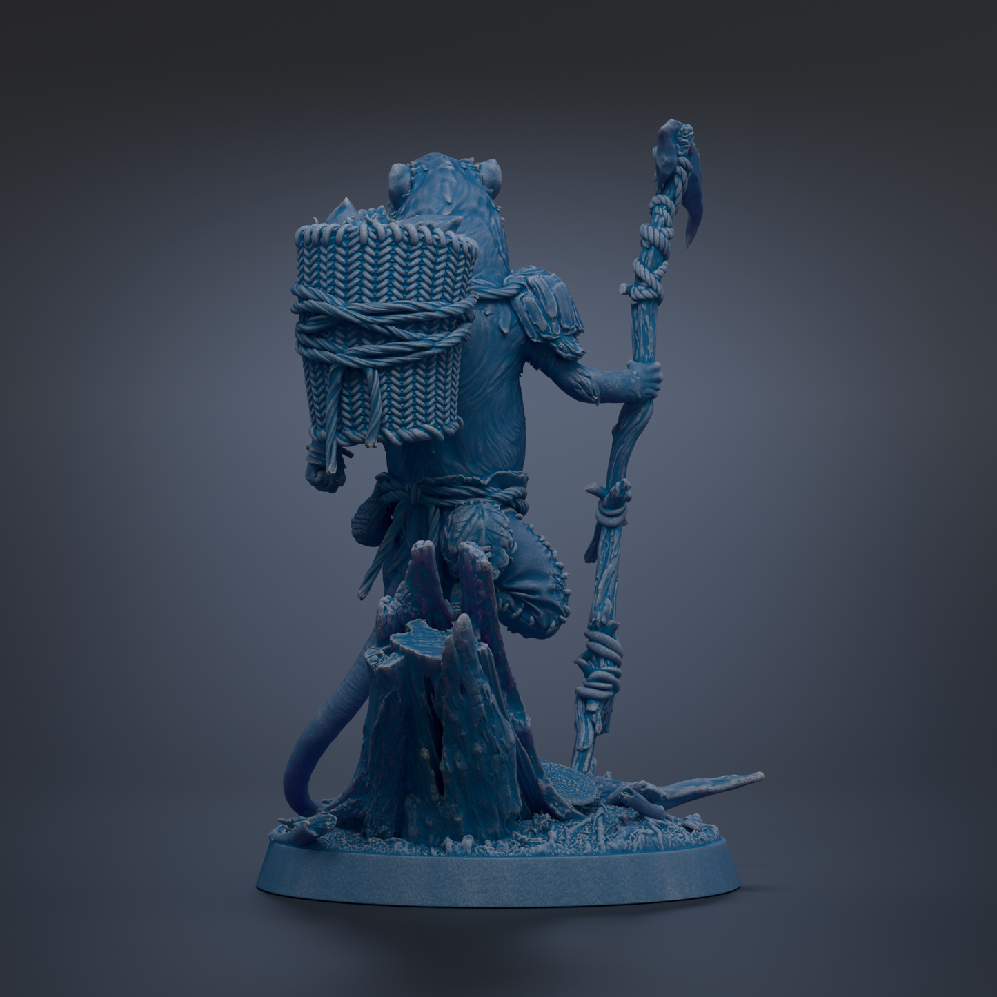A blue figurine of a fantastical creature, possibly a dragon or serpent, holding a staff and a bundle of items, standing on a rock formation.