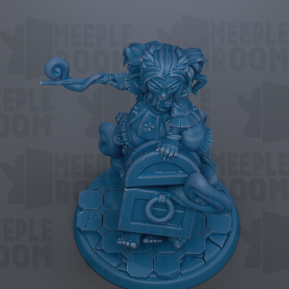 A blue figurine of a fantastical creature, possibly a dragon or serpent, sitting on a pedestal and holding a staff.