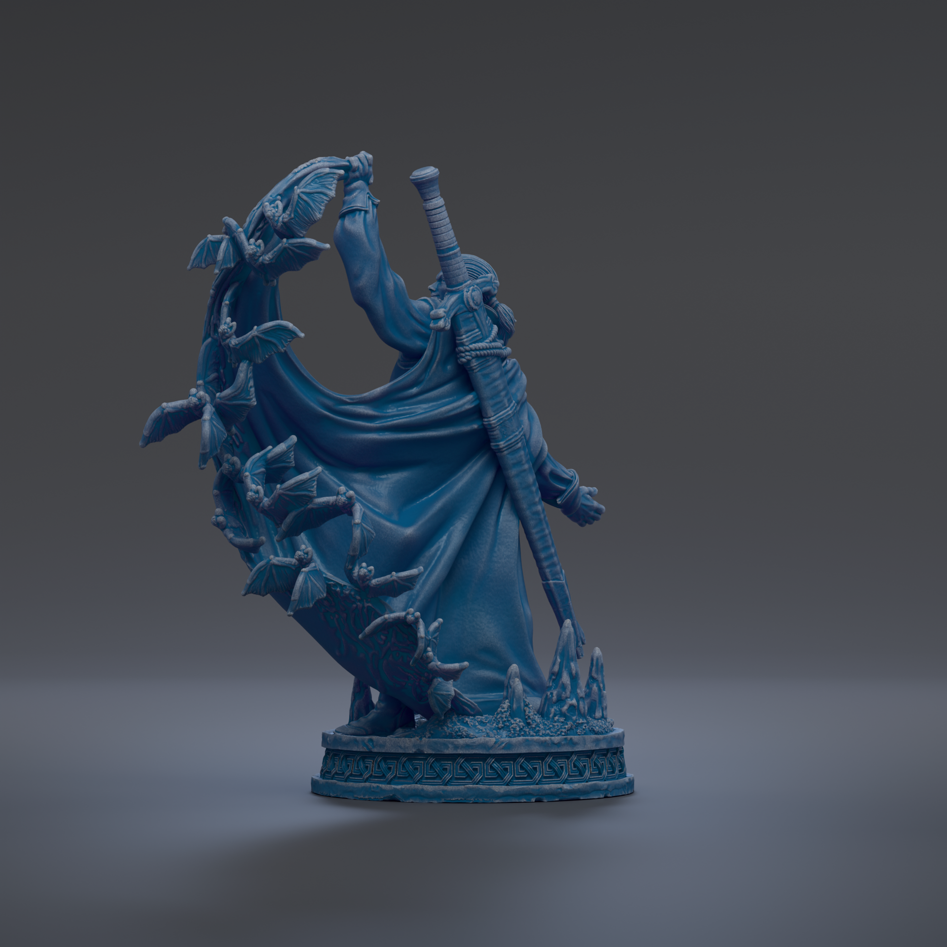 A blue statue of a figure holding a sword and surrounded by bats, standing on a base with a decorative design.