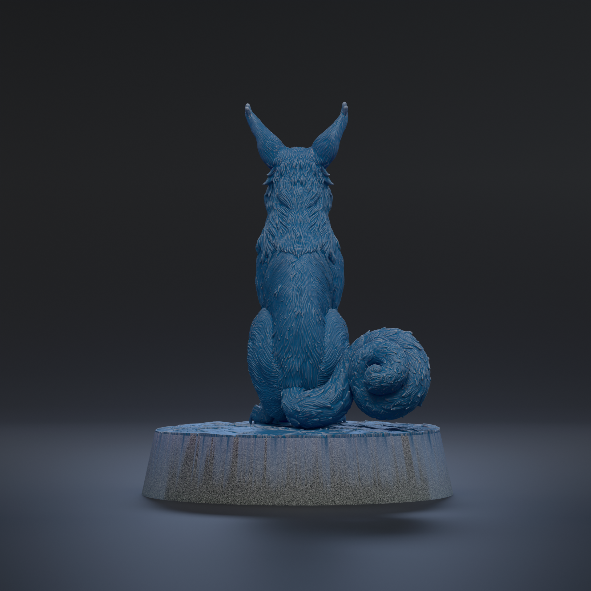 A blue, furry animal with large ears sits on a gray base against a dark background.