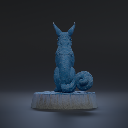 A blue, furry animal with large ears sits on a gray base against a dark background.