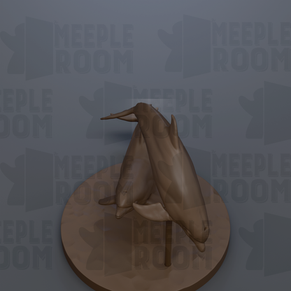 A 3D rendering of a pair of dolphins on a circular base, with the background featuring repeated text that reads "MEEPLE ROOM".