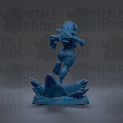 A blue figurine of a female character is shown in a dynamic pose, standing on a base with a rocky terrain.