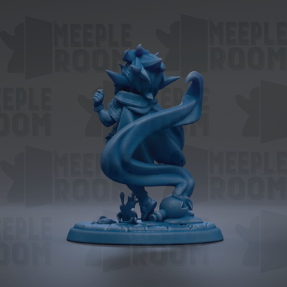 A blue figurine of a character with a flowing cape and spikes, standing on a base with a textured surface.