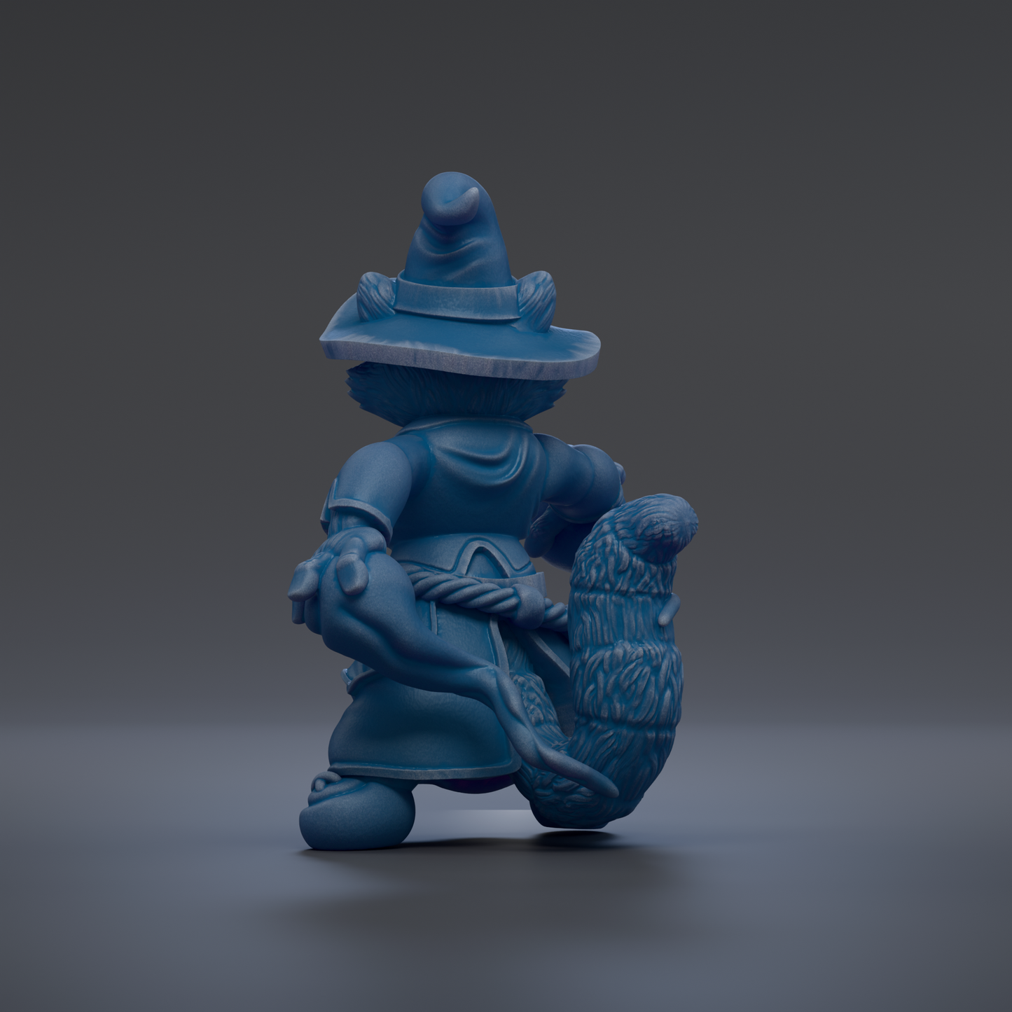 A blue, whimsical figurine of a character with a pointed hat and a long, flowing tail, standing on a gray surface.