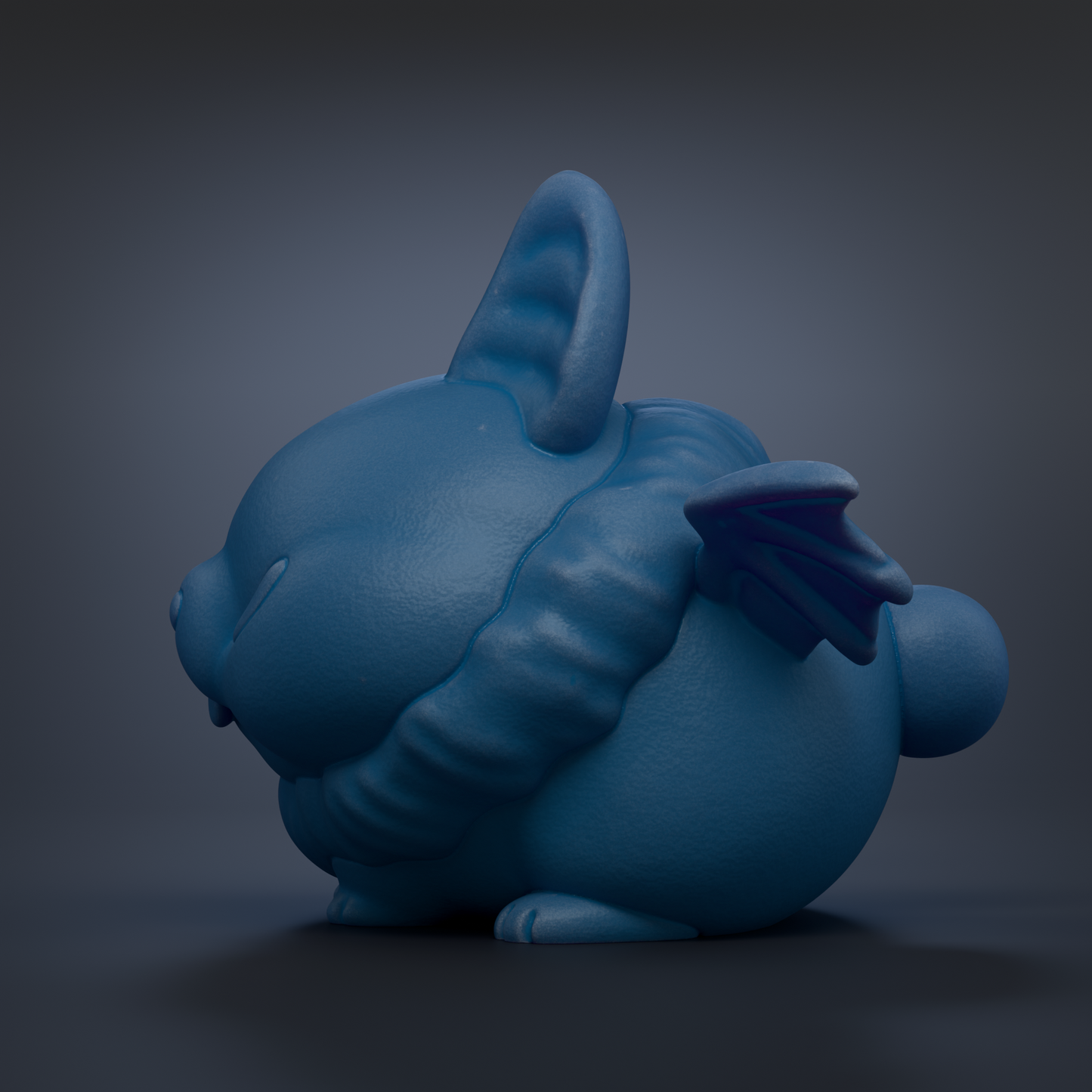 A blue, winged rabbit figurine is shown against a dark background.