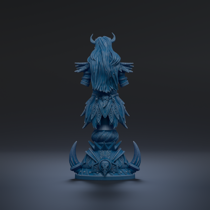 A blue statue of a woman with long hair and horns, standing on a pedestal with ornate designs.