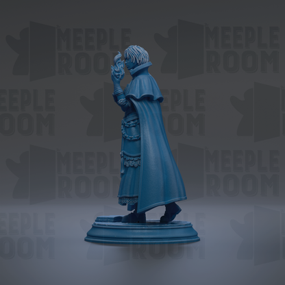 A blue statue of a person standing on a pedestal, wearing a cape and holding a staff.