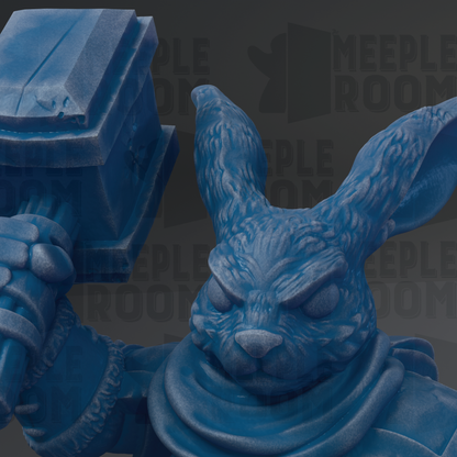 A close-up of a blue, cartoonish rabbit statue holding a hammer.