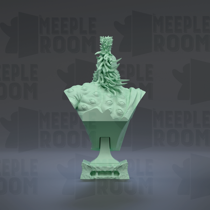 A green, sculpted object resembling a plant or flower, with a textured surface and a pointed top, set against a dark background with repeated text.