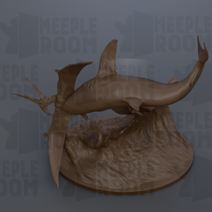 A bronze sculpture of a shark and a bird, likely a shark-pterosaur, displayed on a circular base.