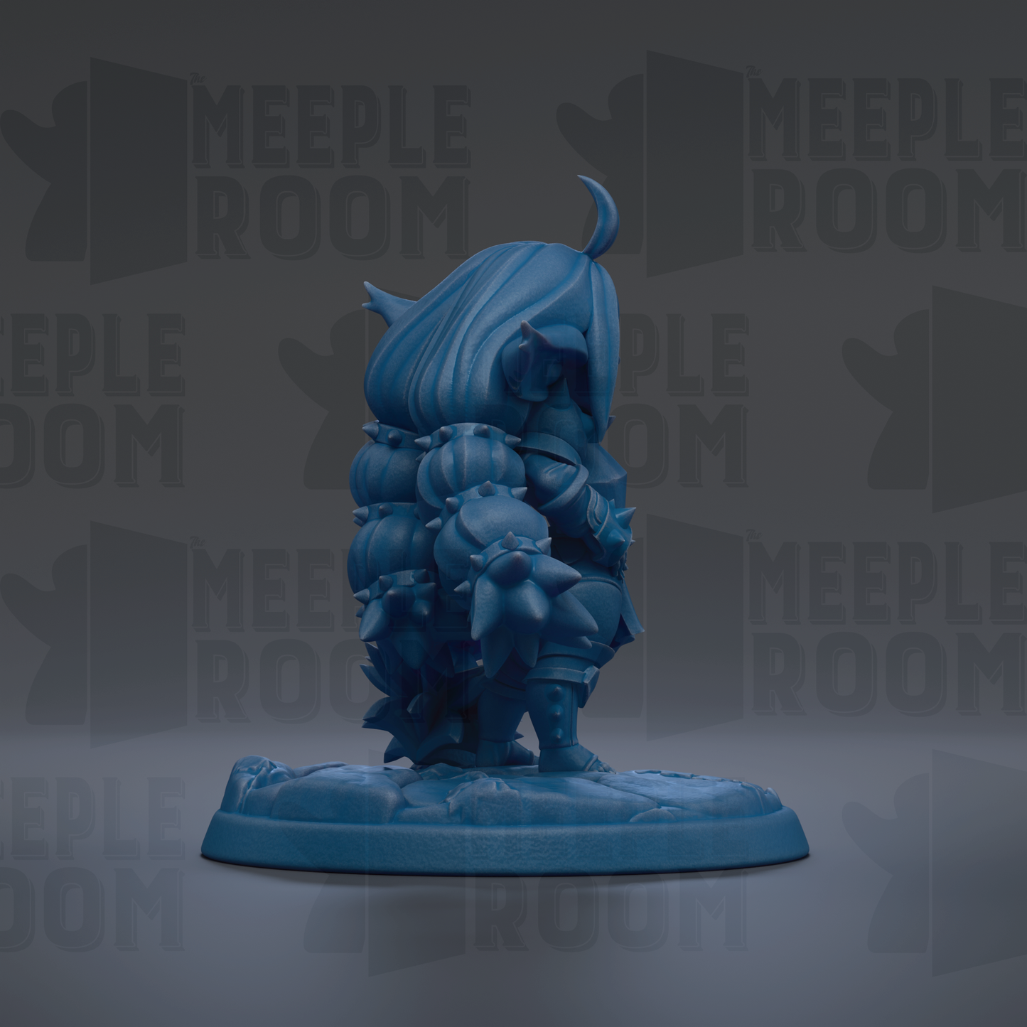 A blue figurine of a character with a crescent moon on its head, standing on a base.