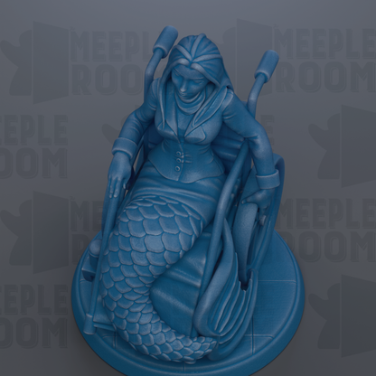 A blue mermaid statue sitting in a wheelchair, with the text "MEEPLE ROOM" visible in the background.