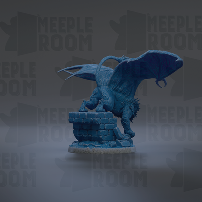 A blue dragon figurine with wings spread, standing on a brick base.