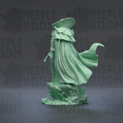 A green statue of a figure with flowing robes stands on a rock formation against a dark background with repeated text.