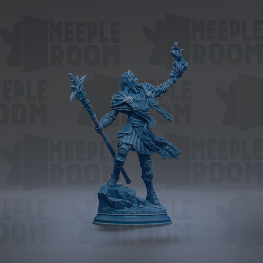 A blue figurine of a warrior standing on a rock, holding a staff and a shield, with a raised fist.