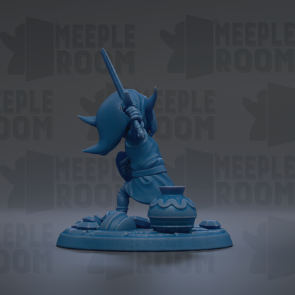 A blue figurine of a character holding a sword and standing on a platform.